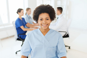 Image showing doctor or nurse over group of medics at hospital