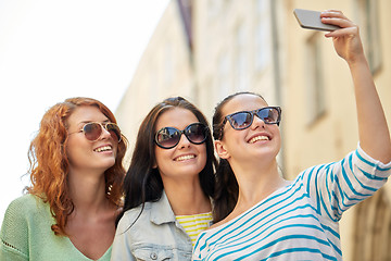 Image showing smiling young women taking selfie with smartphone