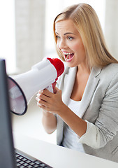 Image showing crazy businesswoman shouting in megaphone