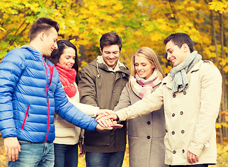 Image showing group of smiling men and women in autumn park