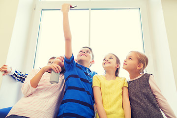 Image showing group of school kids with smartphone and soda can