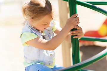 Image showing happy little girl climbing on children playground