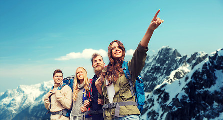 Image showing group of smiling friends with backpacks hiking