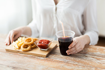 Image showing close up of woman with snacks and cola