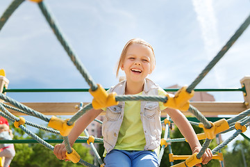 Image showing happy little girl climbing on children playground