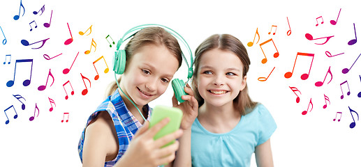 Image showing happy girls with smartphone and headphones