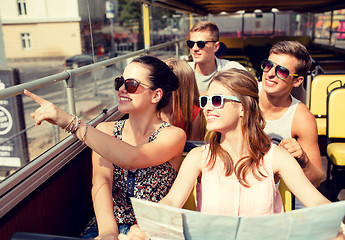 Image showing group of smiling friends traveling by tour bus