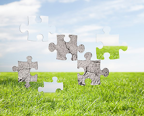 Image showing concrete puzzle over blue sky and grass background