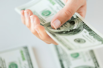 Image showing close up of woman hand counting us dollar money