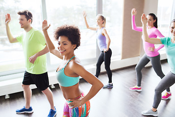 Image showing group of smiling people dancing in gym or studio