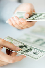 Image showing close up of woman hands counting us dollar money