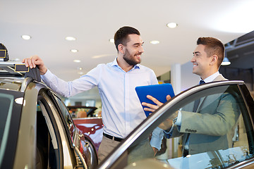 Image showing happy man with car dealer in auto show or salon