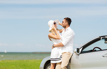 Image showing happy man and woman hugging near car at sea