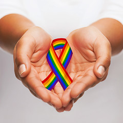 Image showing hands holding rainbow gay pride awareness ribbon