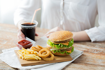 Image showing close up of woman with fast food and cola