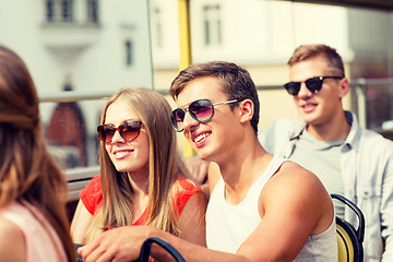 Image showing smiling couple traveling by tour bus