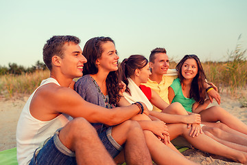 Image showing smiling friends in sunglasses on summer beach