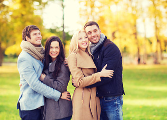 Image showing group of smiling men and women in autumn park