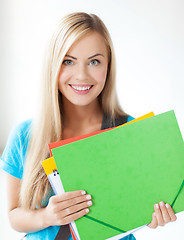 Image showing smiling student with folders