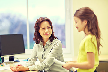 Image showing school girl with notebook and teacher in classroom