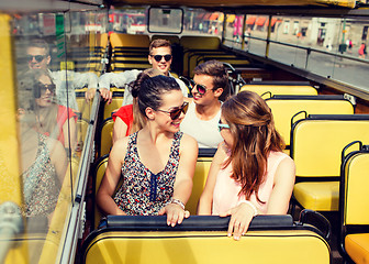 Image showing group of smiling friends traveling by tour bus