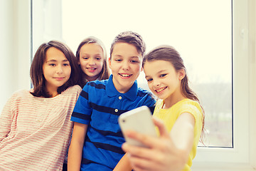 Image showing group of school kids taking selfie with smartphone