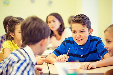 Image showing group of school kids writing test in classroom