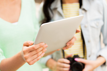 Image showing close up of women with tablet pc and camera