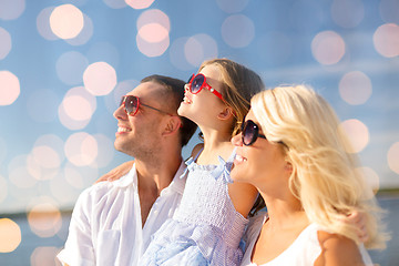 Image showing happy family over blue lights background