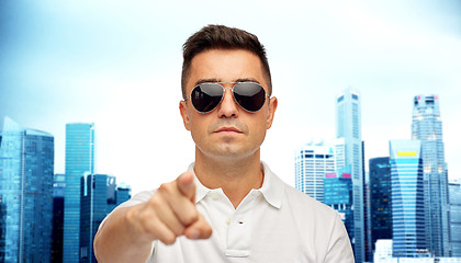 Image showing man in sunglasses pointing finger on you