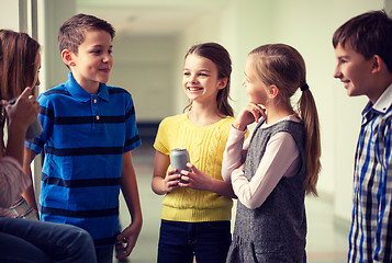 Image showing group of school kids with soda cans in corridor