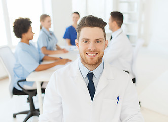 Image showing happy doctor over group of medics at hospital