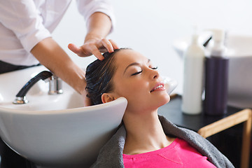 Image showing happy young woman at hair salon