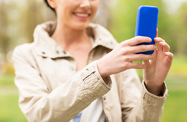 Image showing close up of woman taking picture with smartphone