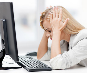 Image showing stressed woman with computer