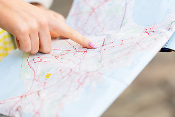 Image showing close up of woman hand pointing finger to map