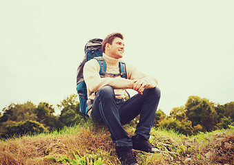 Image showing smiling man with backpack hiking