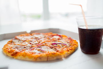 Image showing close up of pizza with cola on table