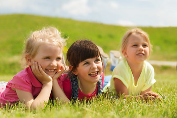 Image showing group of kids lying on blanket or cover outdoors