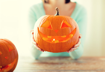 Image showing close up of woman with pumpkins at home