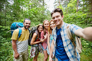 Image showing friends with backpack taking selfie in wood