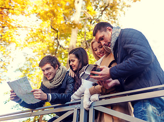 Image showing group of friends with map outdoors