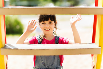 Image showing happy little girl climbing on children playground