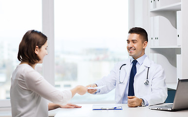 Image showing smiling doctor and young woman meeting at hospital