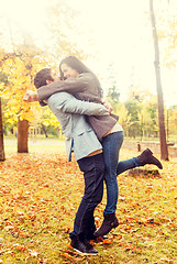 Image showing smiling couple hugging in autumn park