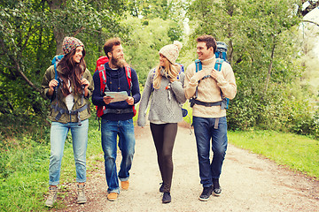 Image showing group of smiling friends with backpacks hiking