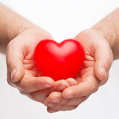 Image showing male hands with small red heart