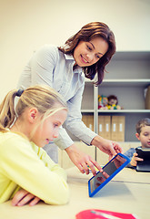 Image showing little girl with teacher and tablet pc at school