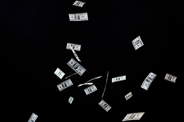 Image showing close up of us dollar money flying over black