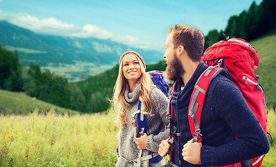 Image showing smiling couple with backpacks hiking